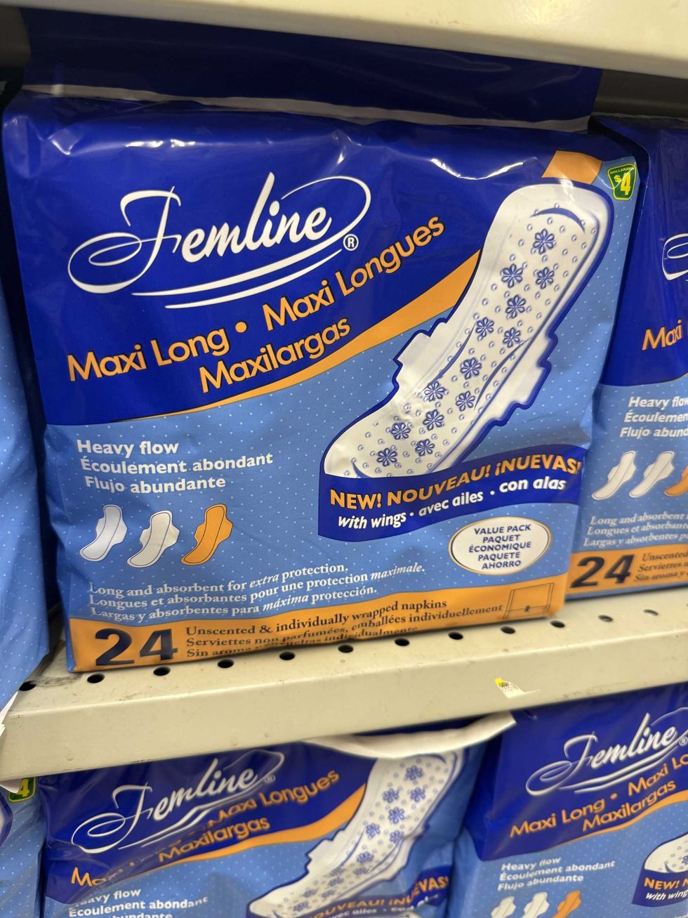 Blue, white and orange bags that say Maxi long heavy flow on the front.