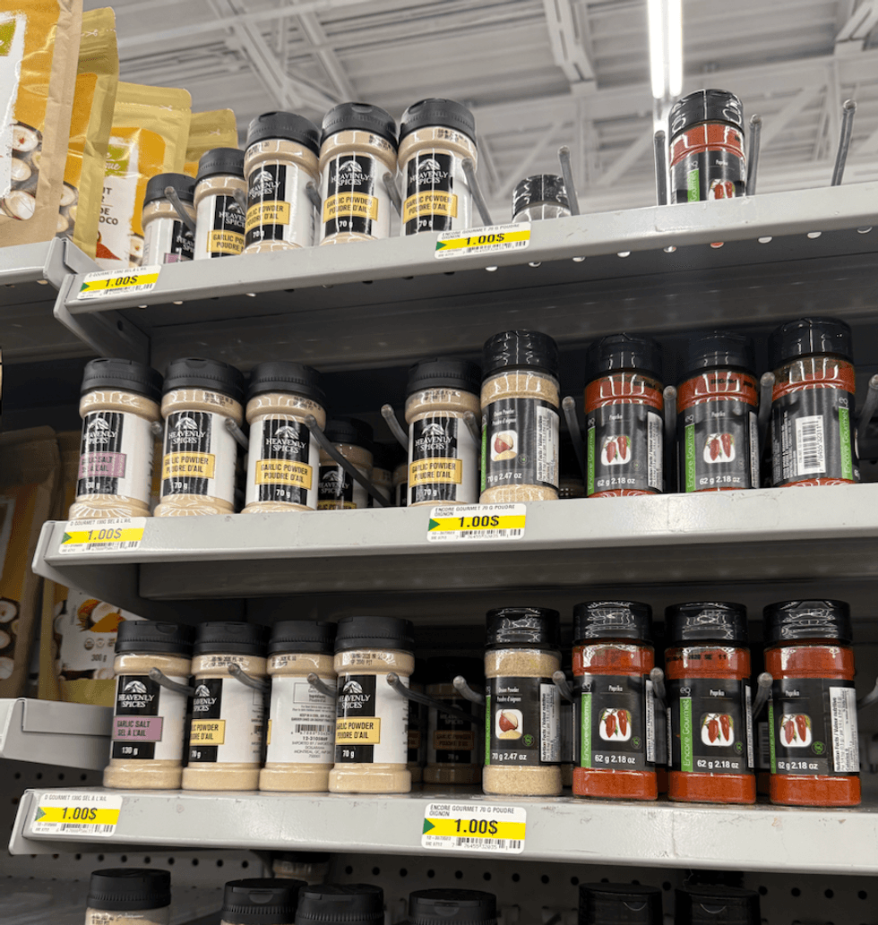 bottles of heavenly spices products including recalled garlic powder on shelves in dollarama store