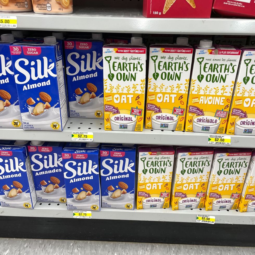 bottles of silk and earth's own almond and oat milk on shelves at dollarama