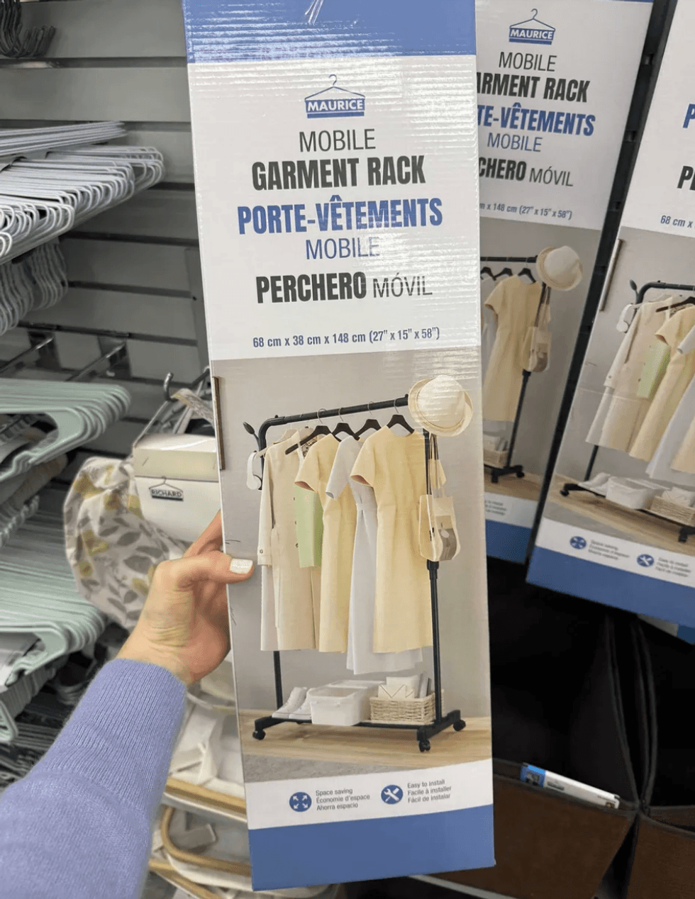 Box of a mobile garment rack in a store, with clothes and items displayed on it.