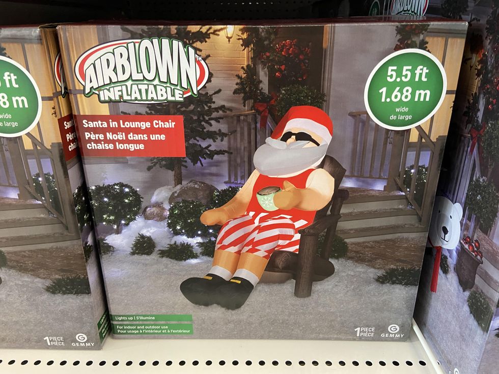 Box of an inflatable Santa decoration lounging in a chair.