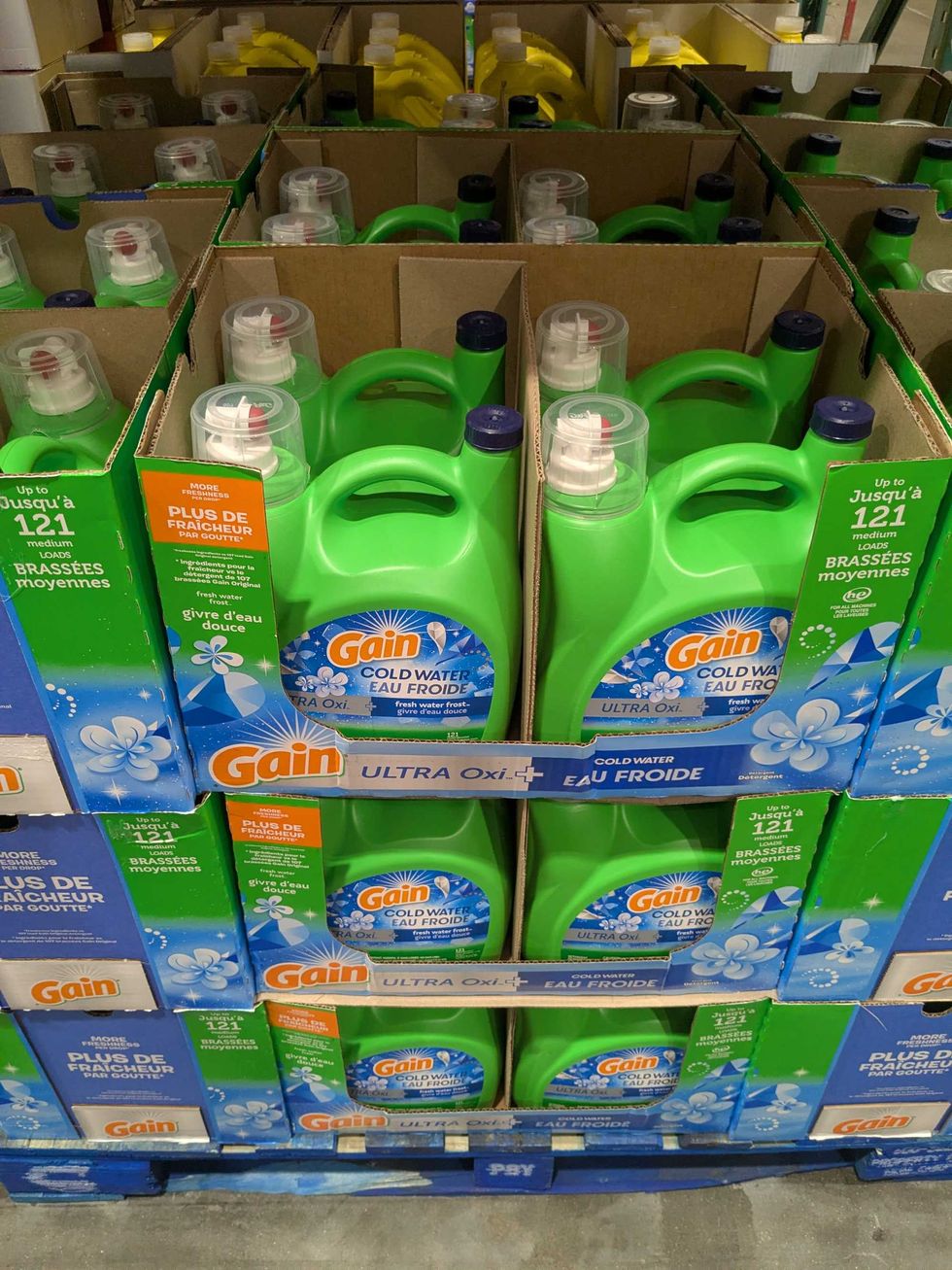 Boxes filled with jugs of laundry soap stacked up