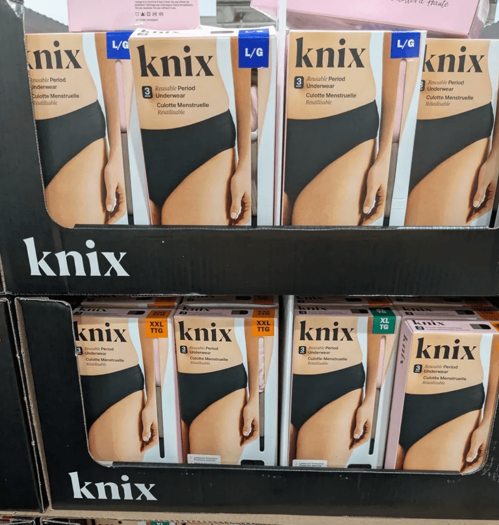 Boxes of Knix reusable period underwear in various sizes displayed on a store shelf.