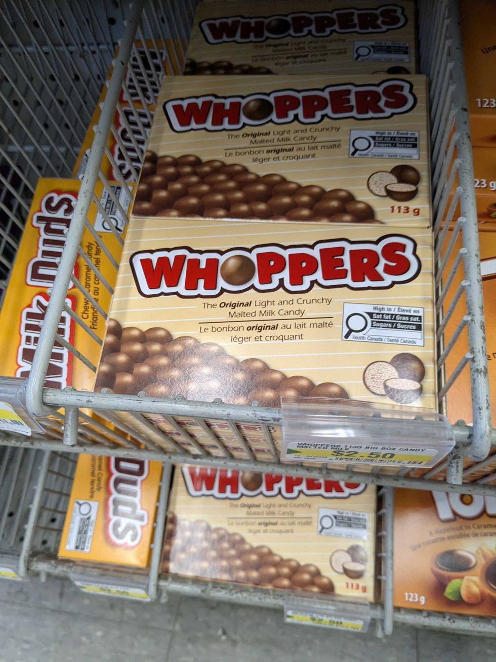 Boxes of Whoppers chocolates on a shelf at Dollarama