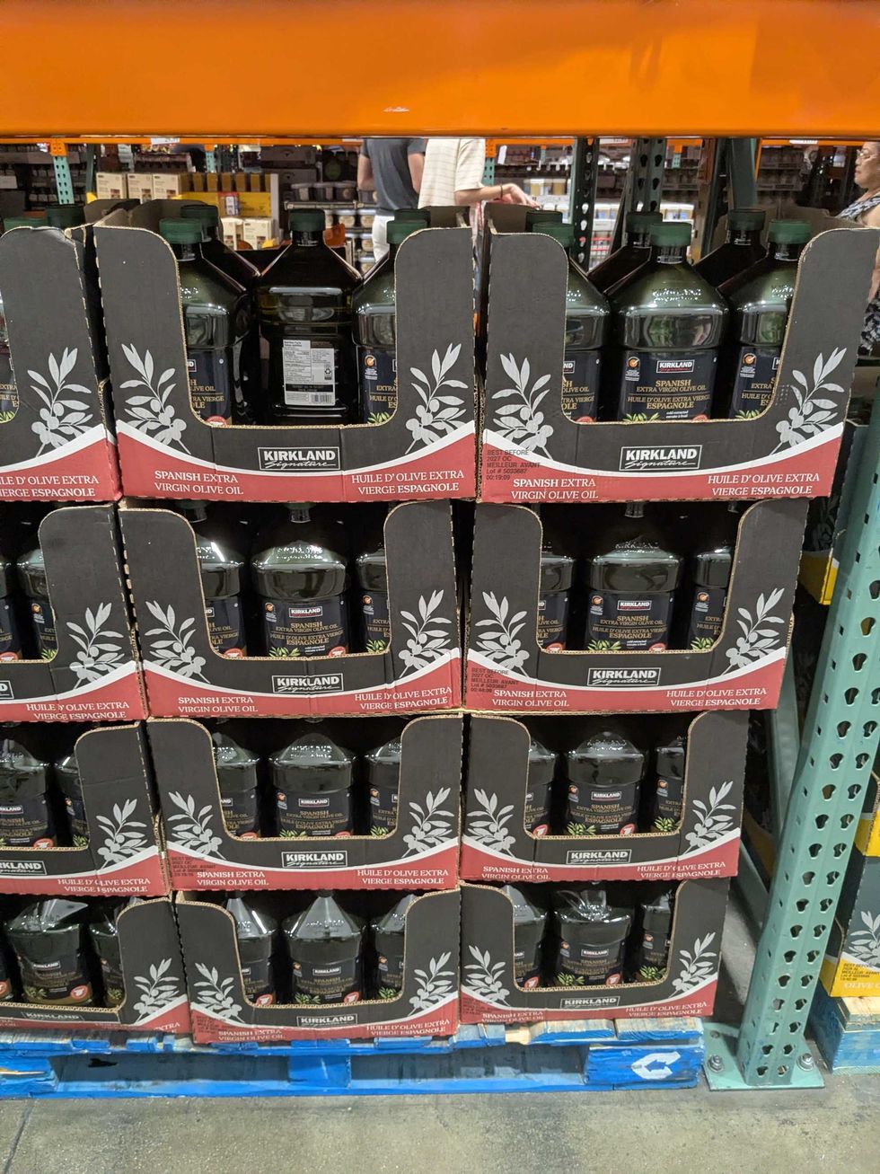 Boxes with large bottles of olive oil on top of a pallet in Costco