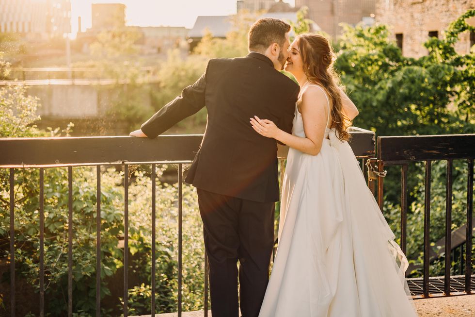 Bride and groom about to kiss during golden hour.