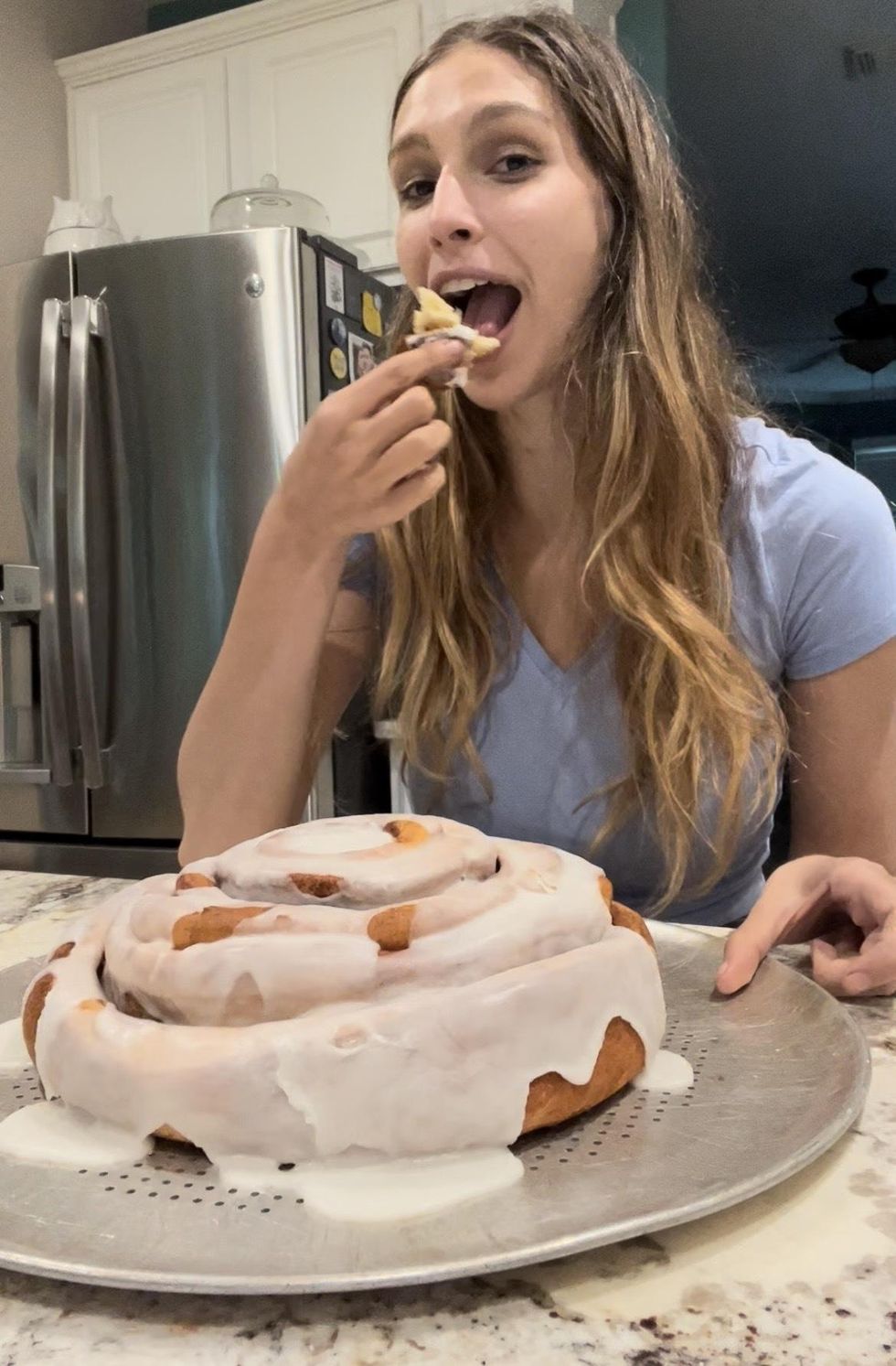 Brittany Cristiano eating the 5-pound cinnamon roll.
