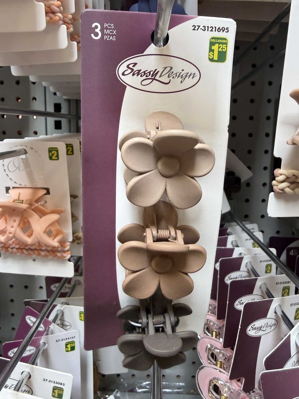 Brown flower hair clips hanging on a store shelf.