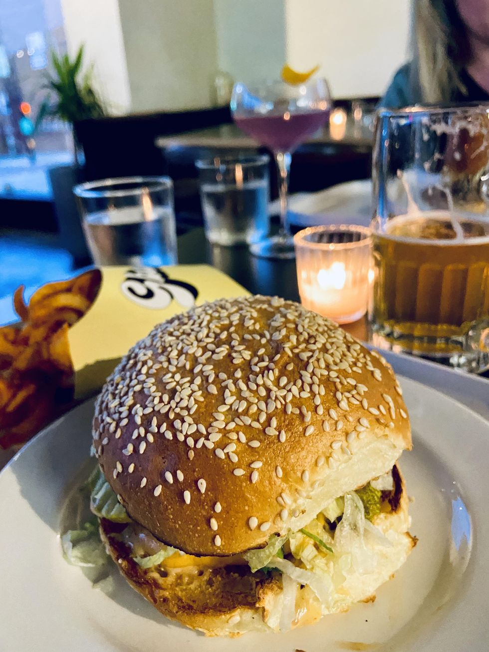 Burger on a sesame bun with spiced fries.