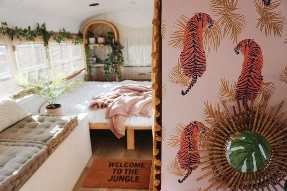 Bus camper with pink decor & plants, This Ontario Campground Motel Is Off The Grid & Has Serious Woodstock Vibes