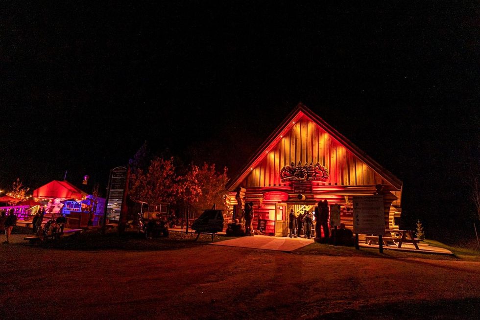 Cabin at Parc Omega lit with eerie orange lights.