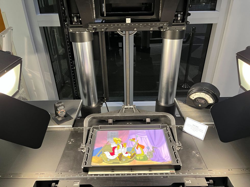 Cameras and lights surround an animation slide depicting characters from a Disney film.