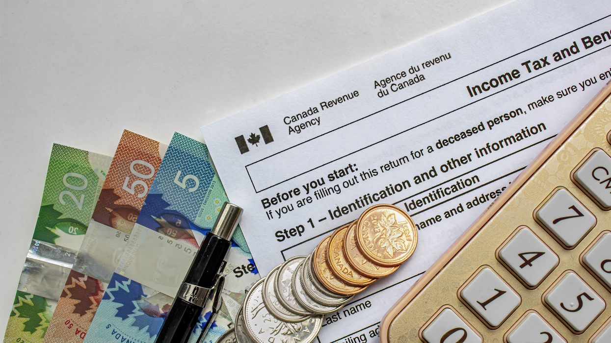 canada revenue agency tax return form with calculator and money