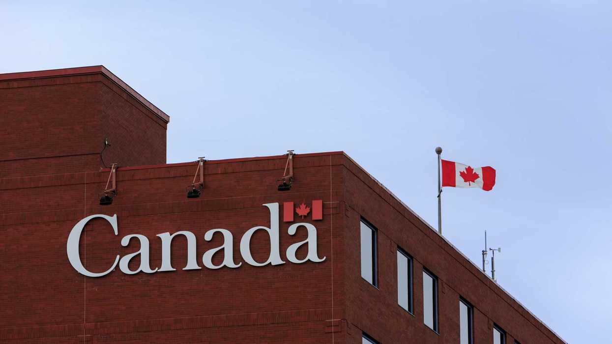 canada sign on government of canada building with canadian flag