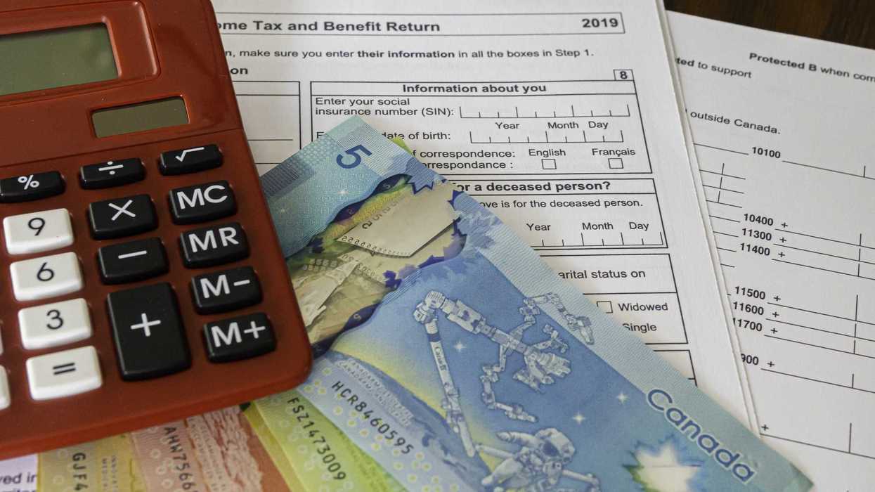 canada tax return forms below canadian banknotes and calculator