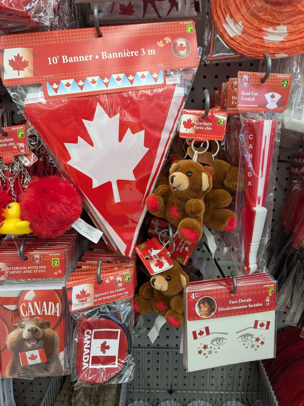 Canada-themed key chains, stickers, and tattoos on a Dollararama shelf