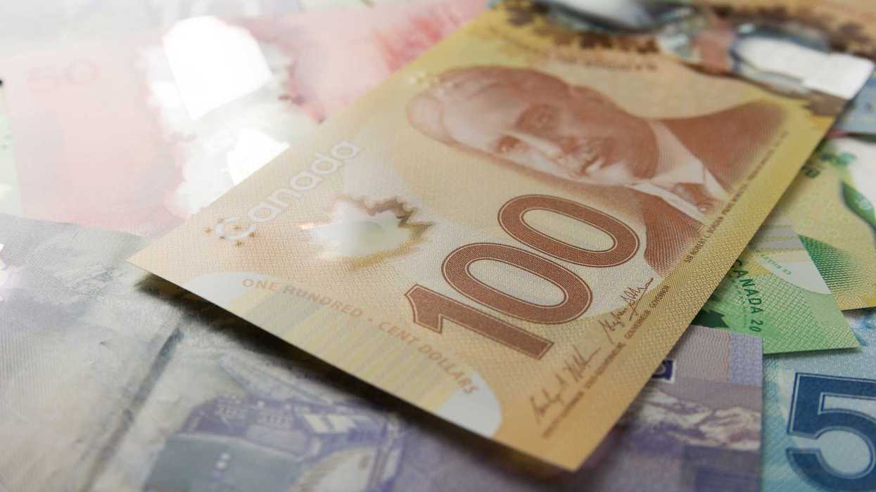 canadian $100 bill on top of canadian banknotes