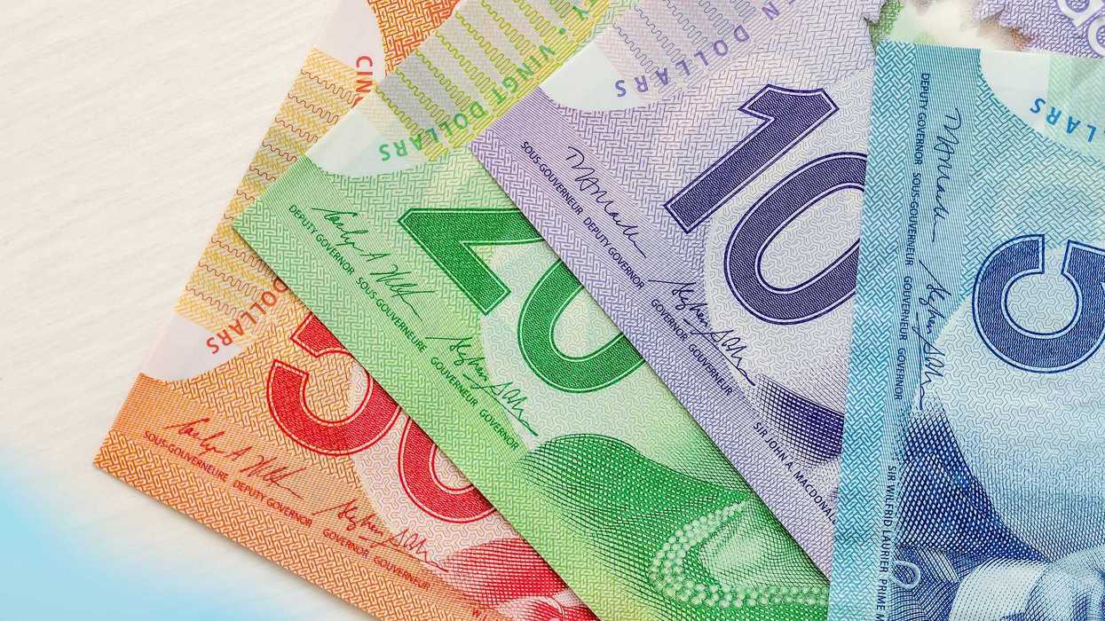 canadian $50, $20, $10 and $5 banknotes fanned out on a table