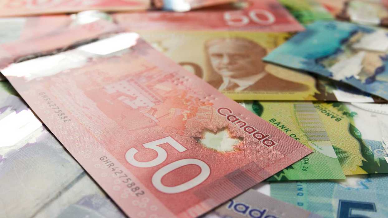 canadian $50 bill on top of other canadian banknotes
