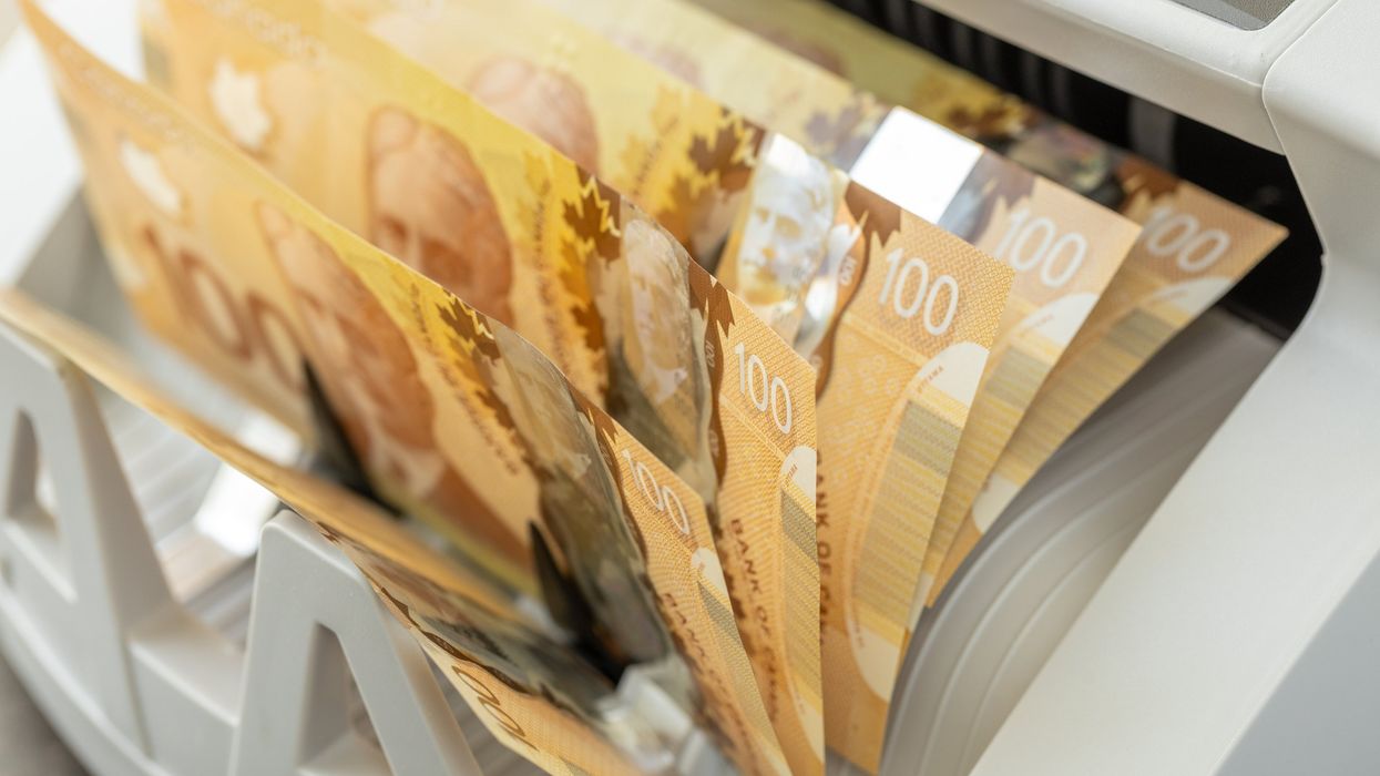 Canadian bills in a counting machine.