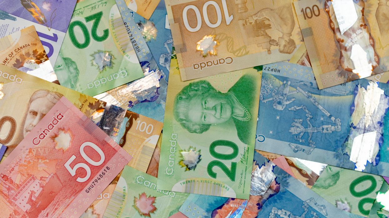 Canadian bills scattered across a surface.
