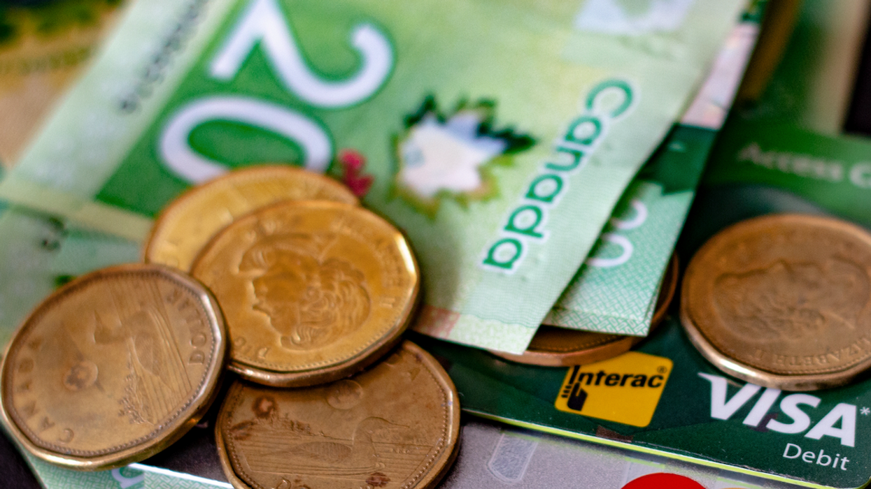 Canadian credit cards and money in a pile.