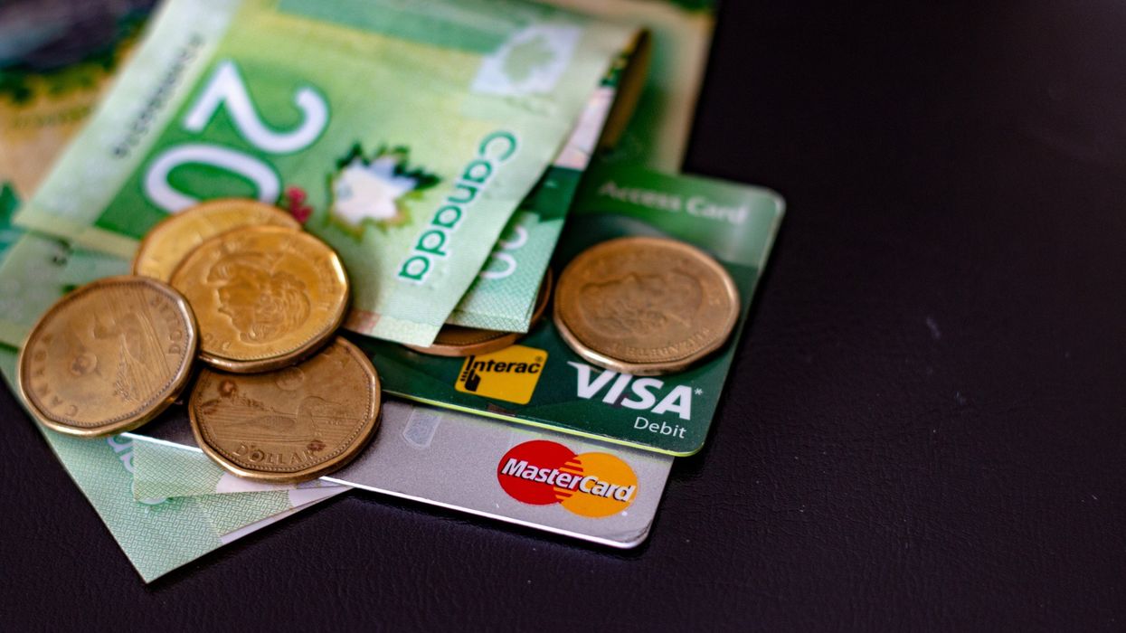 canadian credit cards under a pile of canadian cash