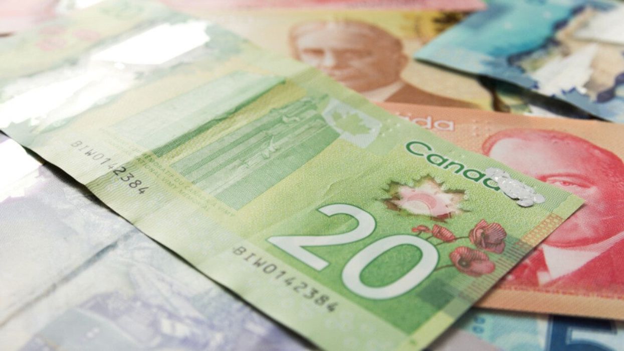 Canadian currency include a green $20 bank note, red $50 bank note.