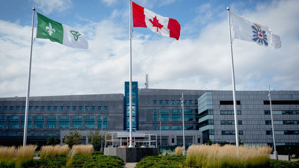 canadian flag and csis flag outside of the headquarters in ottawa, ontario