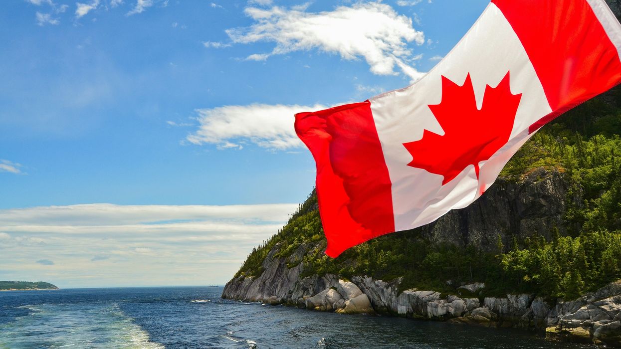 Canadian flag waves on the back of a boat.
