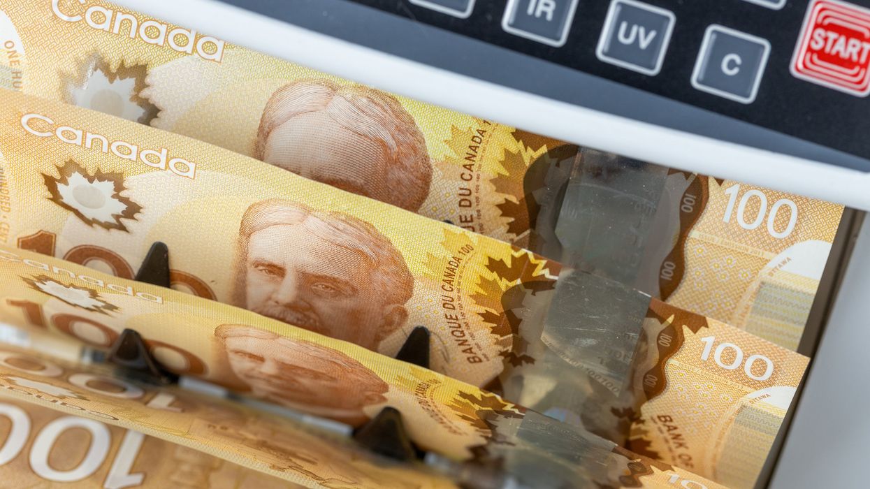 Canadian money in a counting machine.