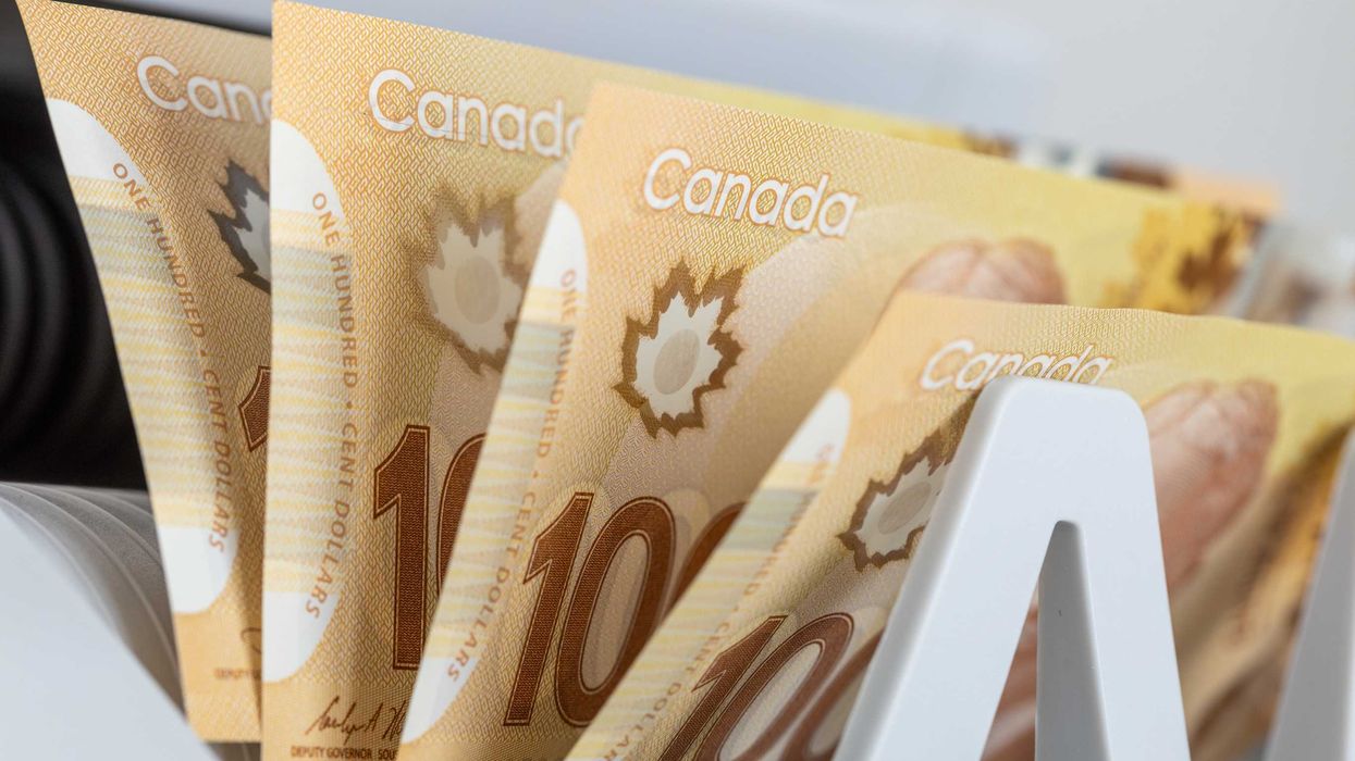 Canadian money in a counting machine.