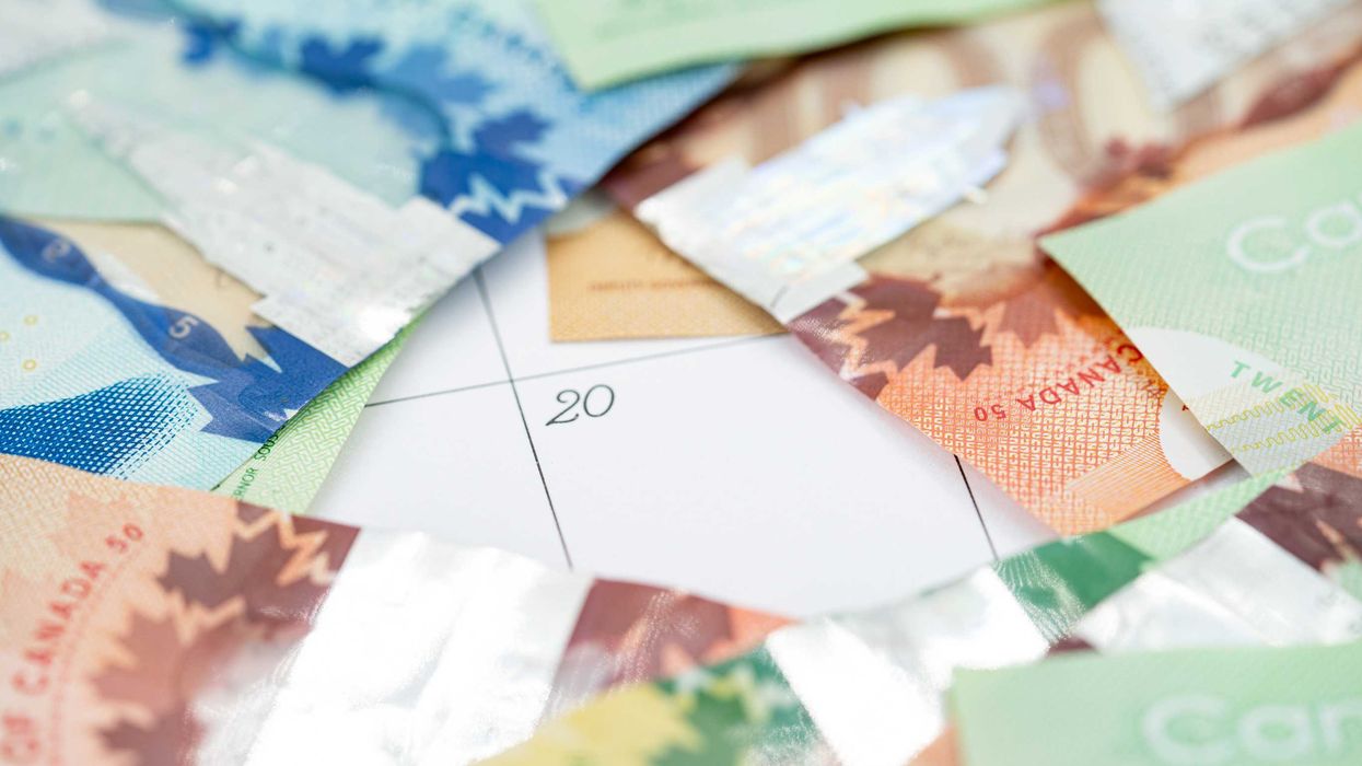 Canadian money strewn over a calendar.