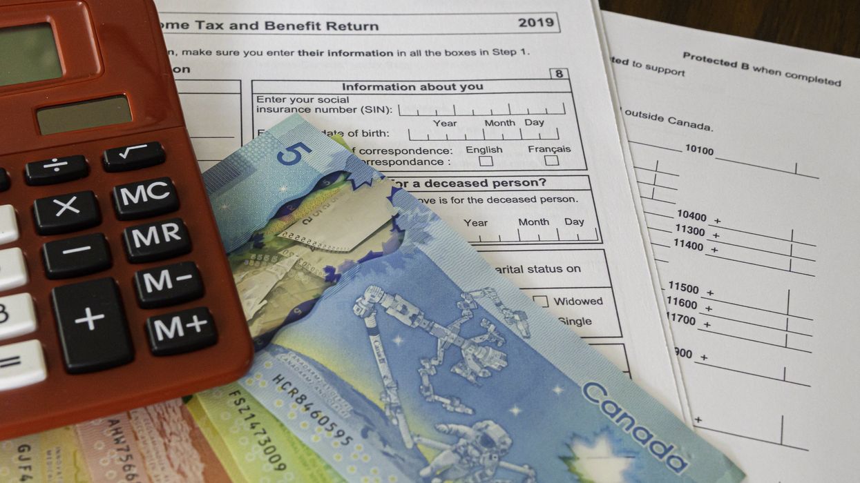 Canadian tax forms, money and a calculator (illustrative).
