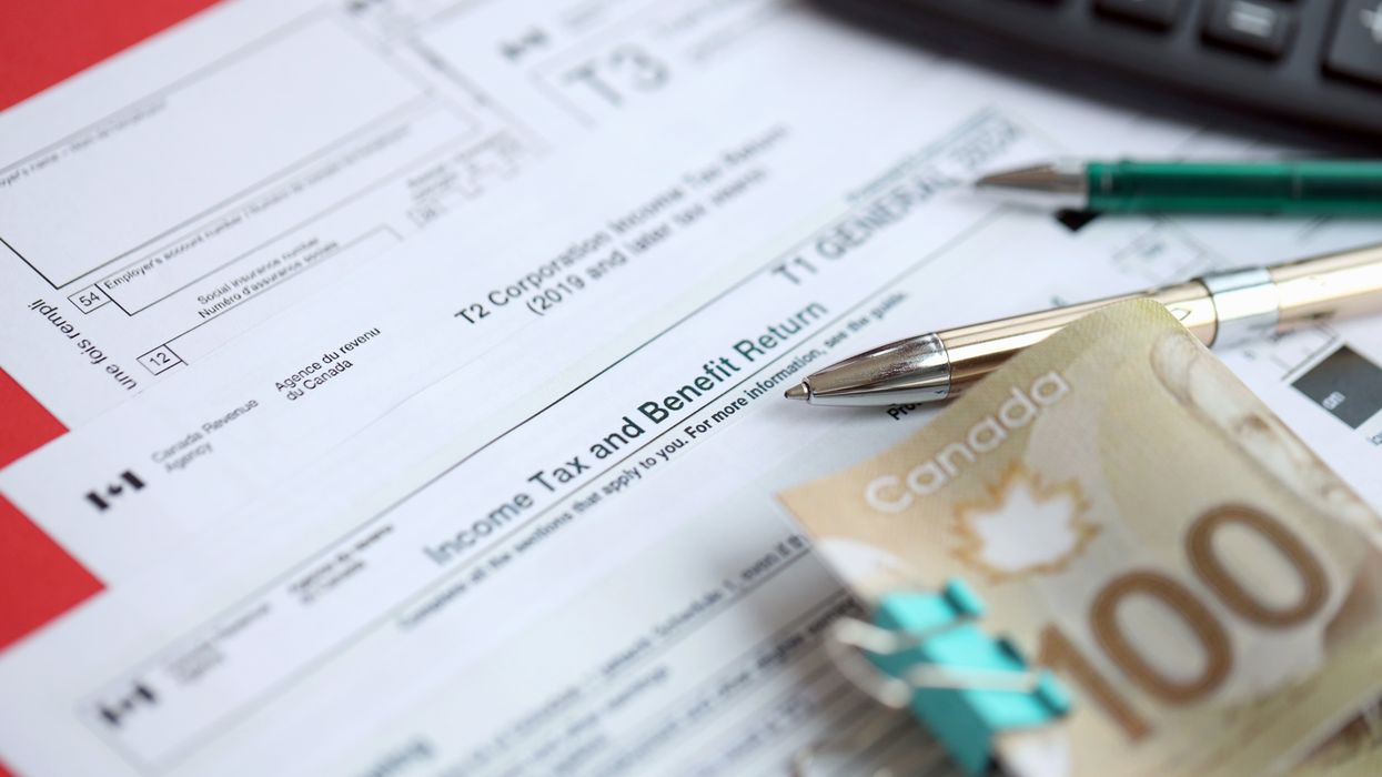 Canadian tax forms, money, pens and a calculator (illustrative).