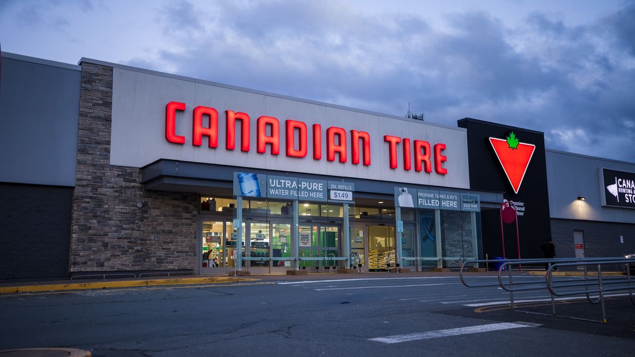 canadian tire storefront at night with lit up sign