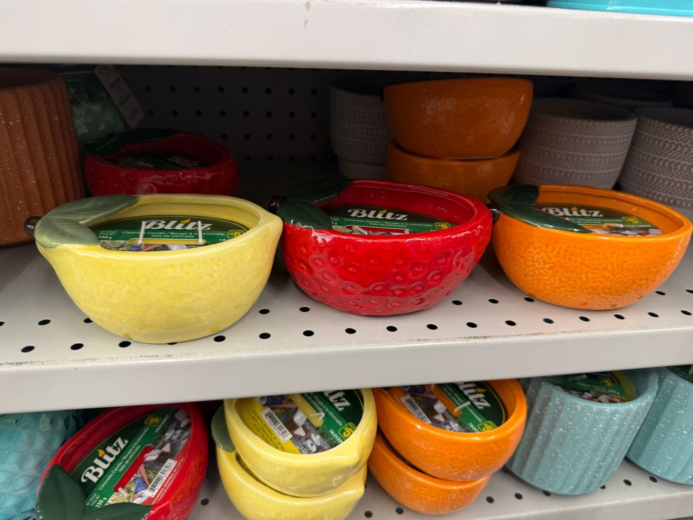 Candles in fruit-shaped bowls, including a lemon, strawberry and orange.