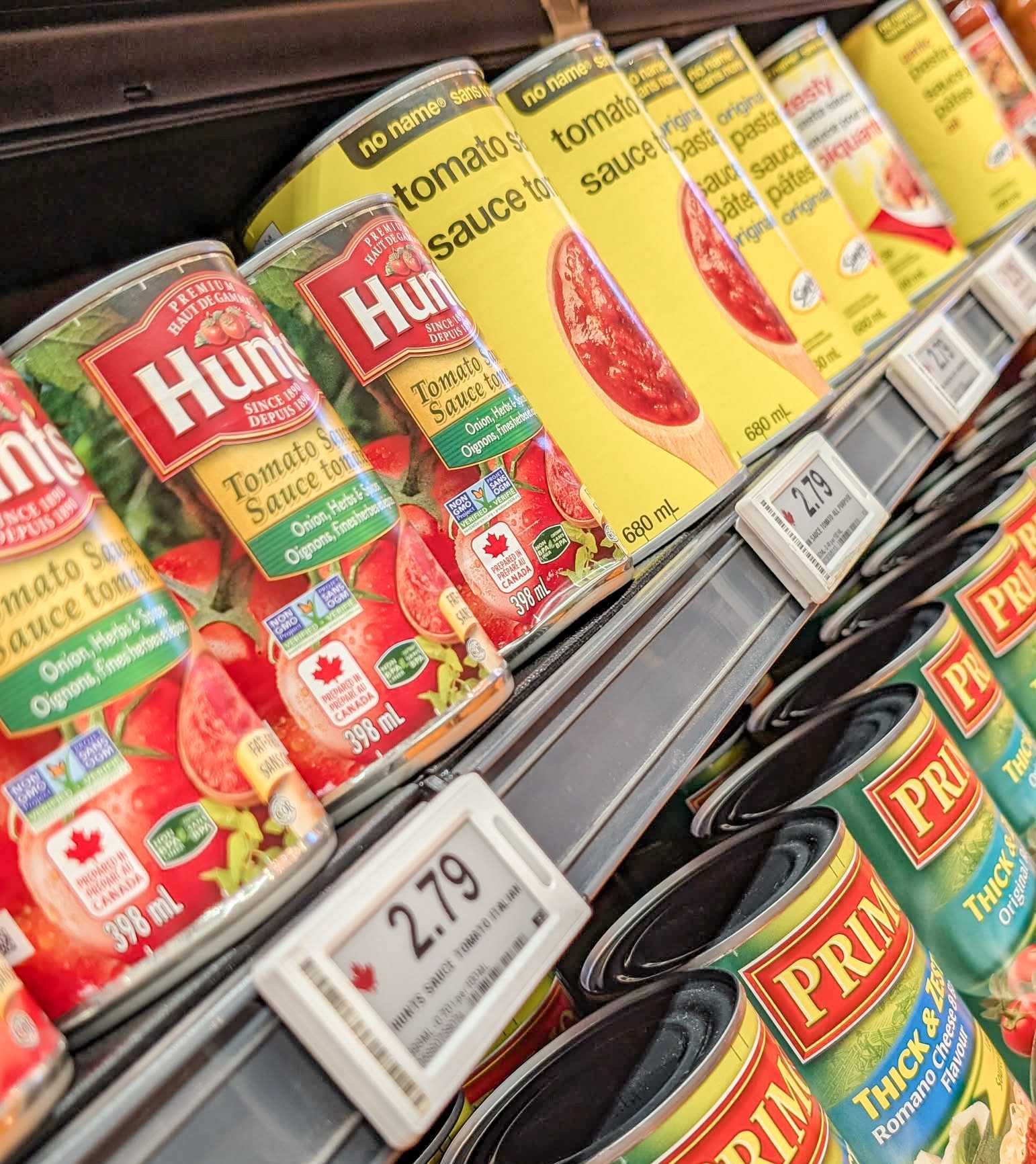 Canned goods on a grocery store shelf.