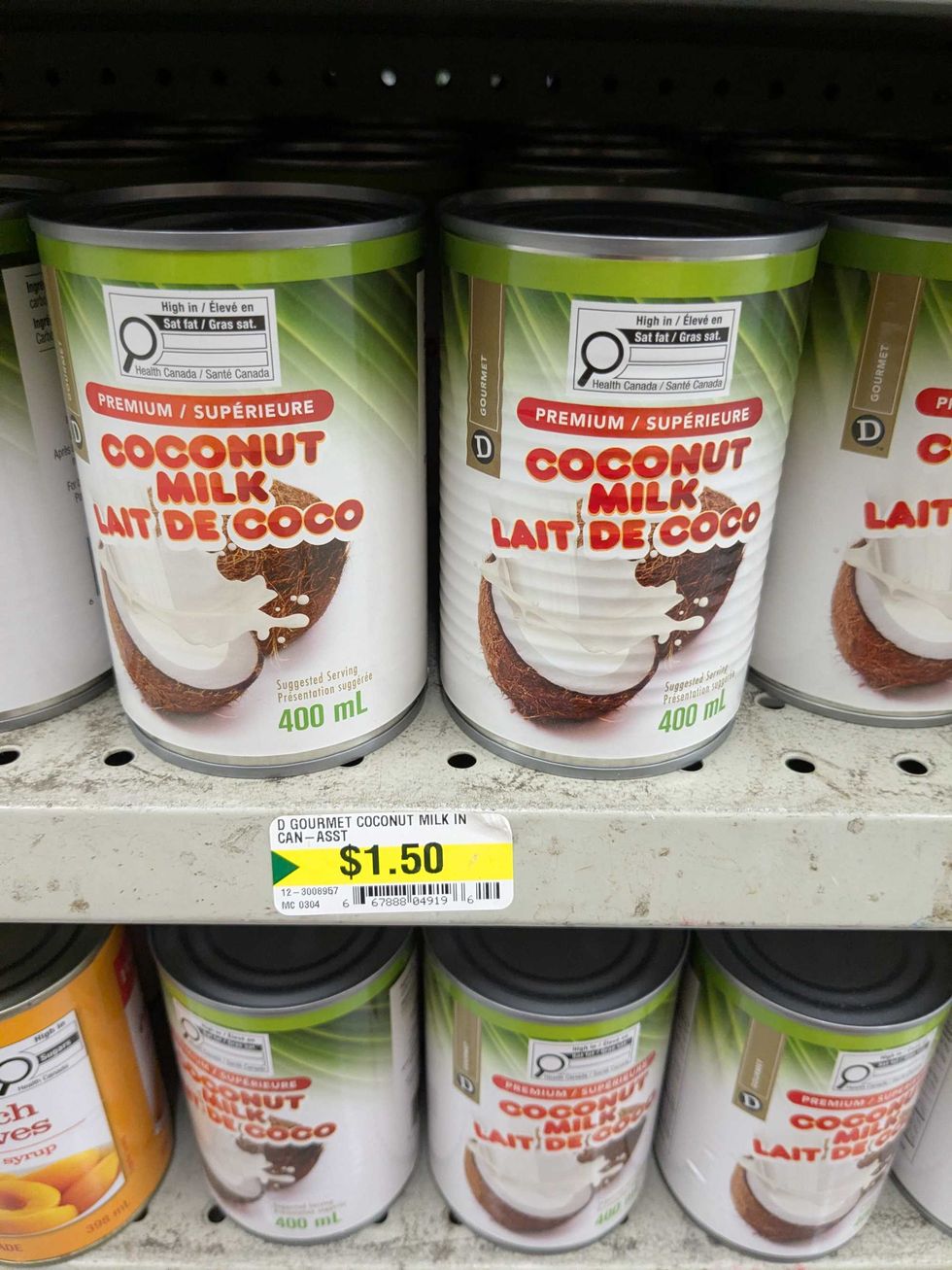 Cans of coconut milk on a shelf at Dollarama