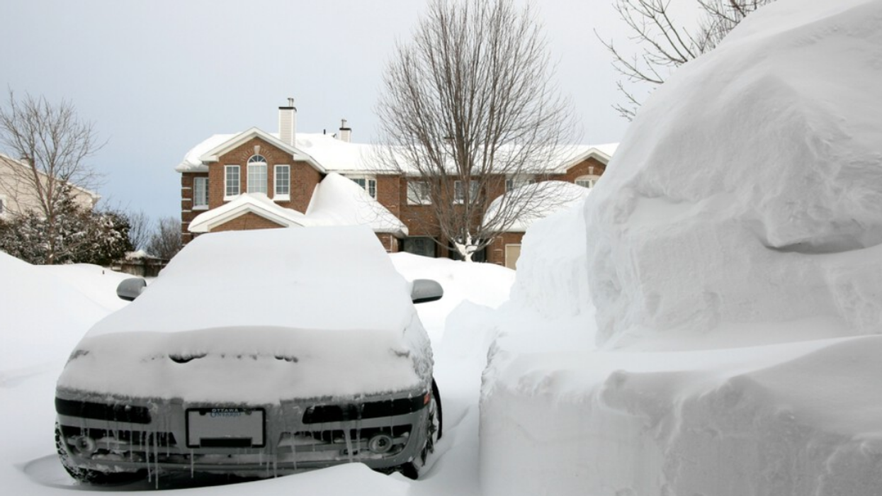 Car covered in snow in Ontario.