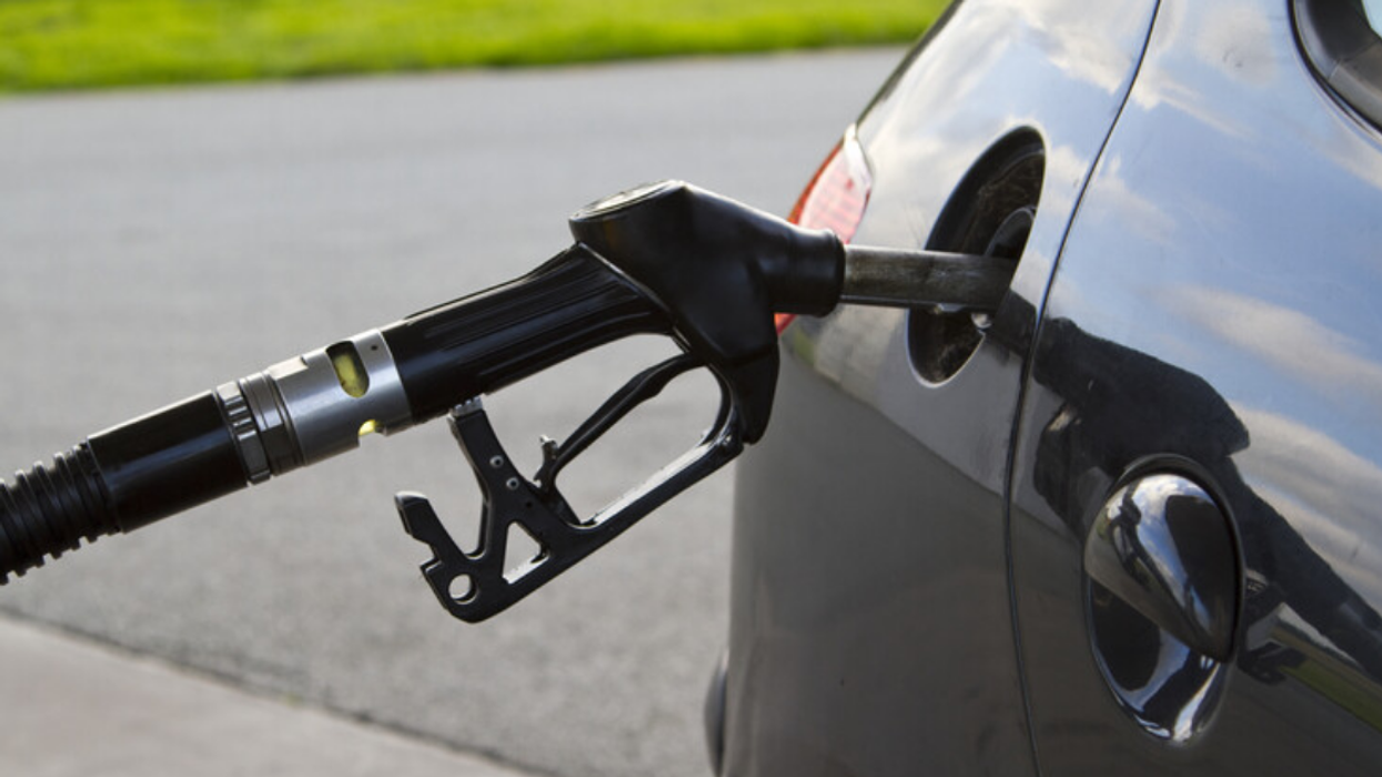 Car filling up on gas.