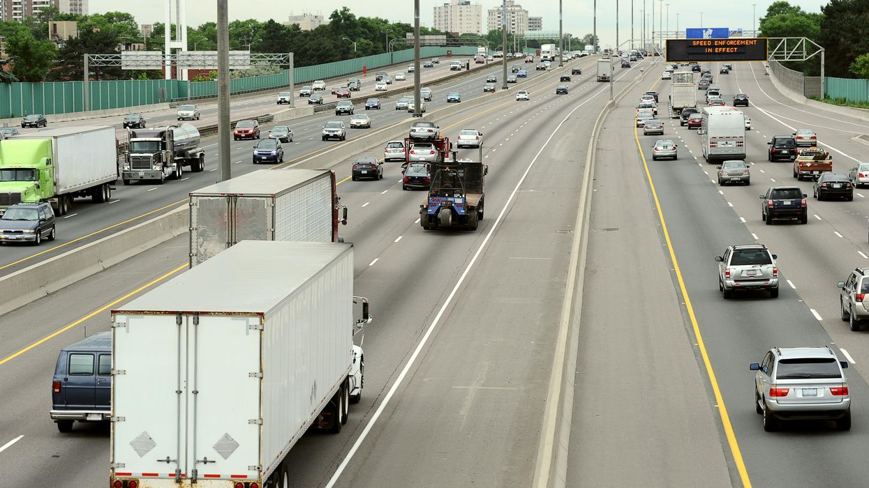 Cars and trucks driving down a Toronto highway.