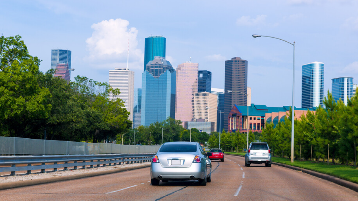 Cars driving on a street in Houston, TX.