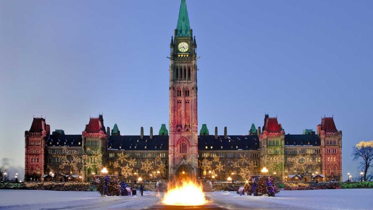 Centre Block Parliament building in Ottawa with Christmas lights.