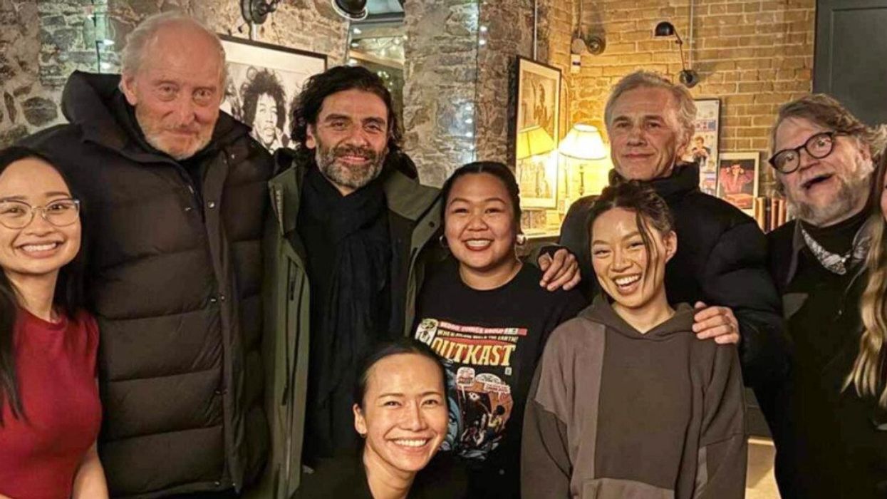 Charles Dance, Oscar Isaac, Christoph Waltz, Guillermo del Toro, and Mia Goth with staff at Pai restaurant in Toronto.