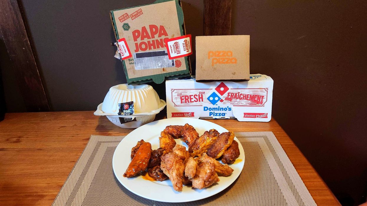 Chicken wings and boxes on a table.