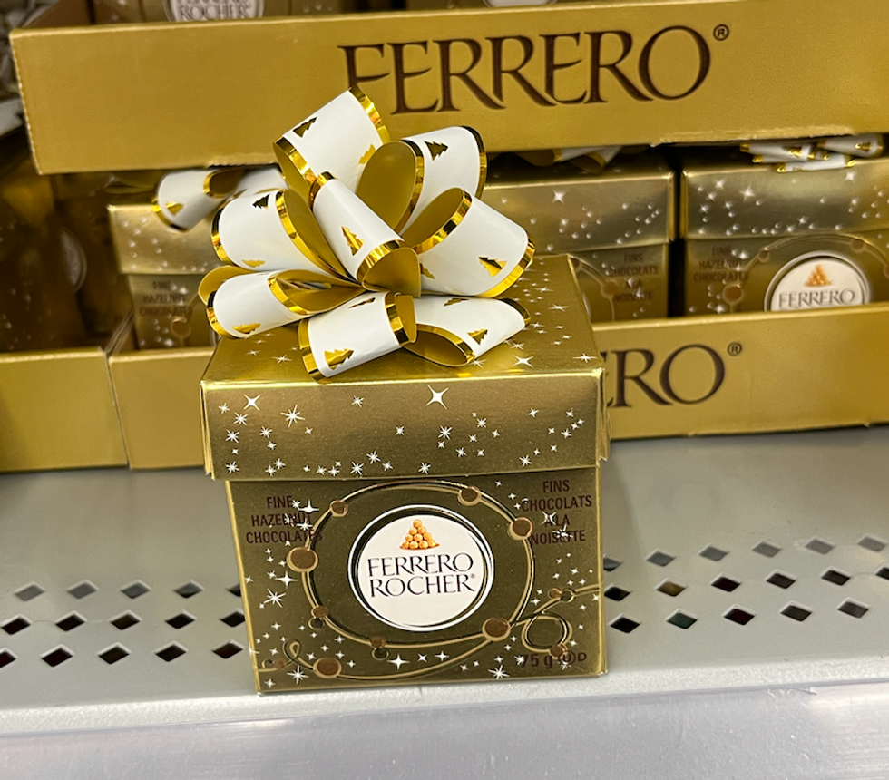 Chocolats Ferrero Rocher dans une bo\u00eete dor\u00e9e sur une tablette.