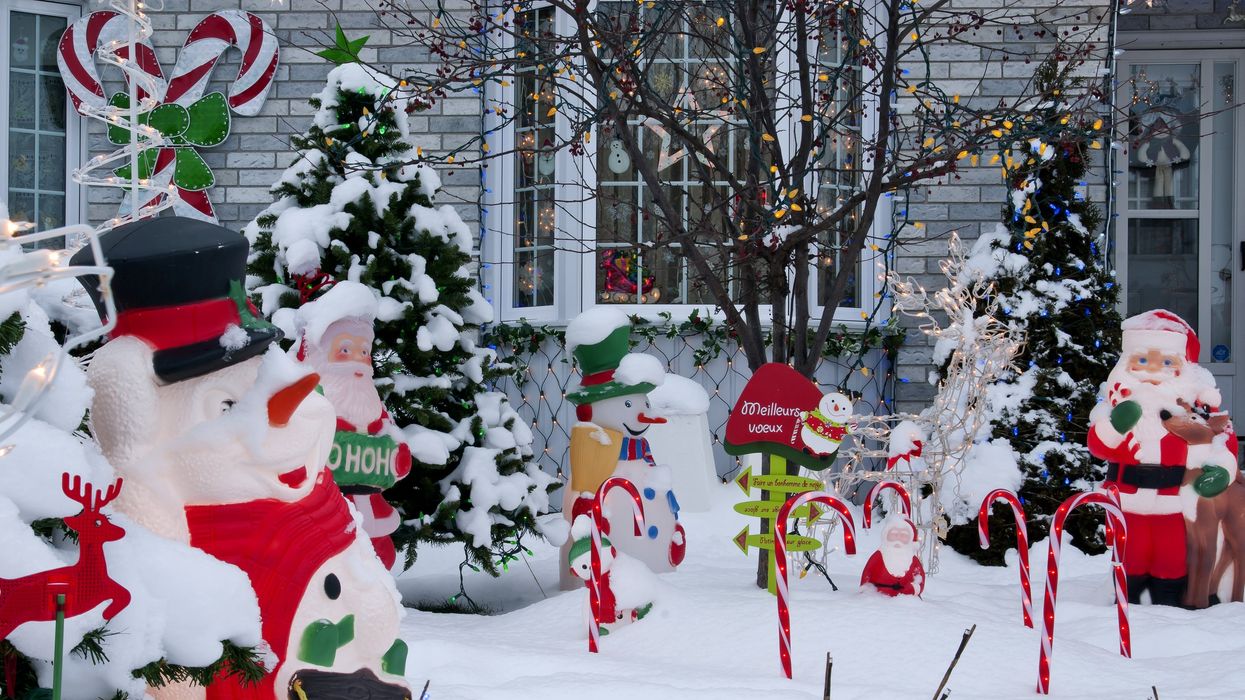 Christmas decorations in a front yard covered in snow.
