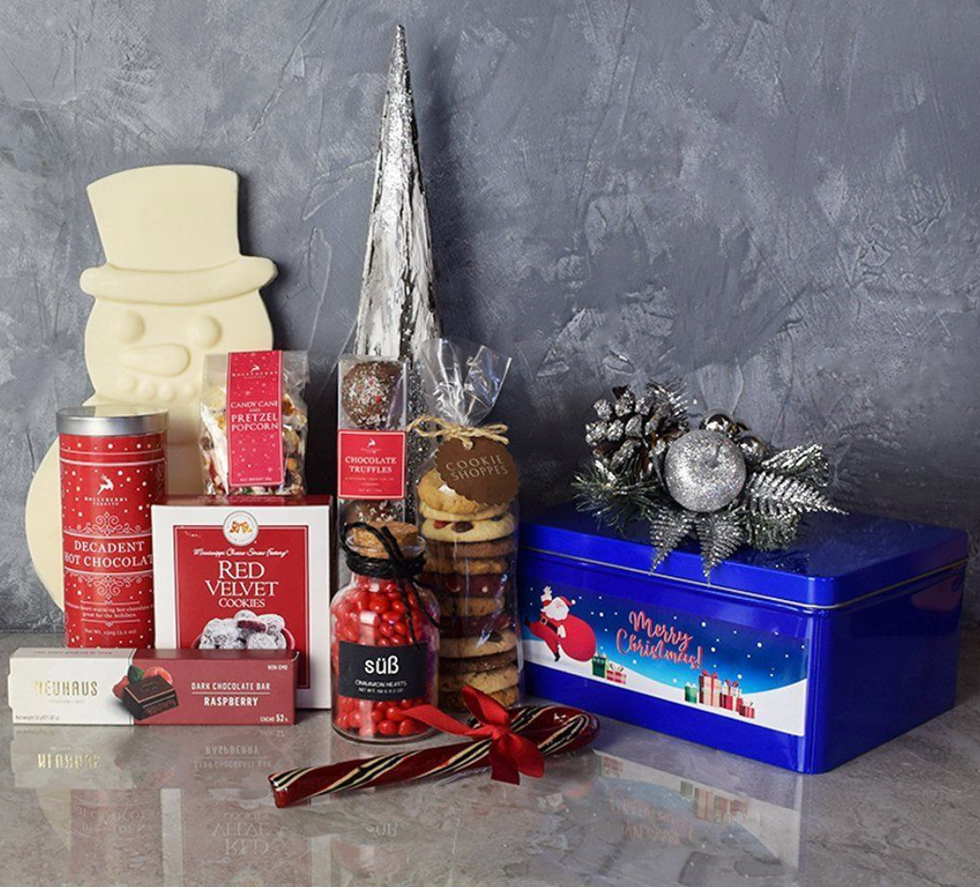 Christmas treats including a chocolate snowman, hot chocolate, candy, red velvet cookies and a dark chocolate bar.