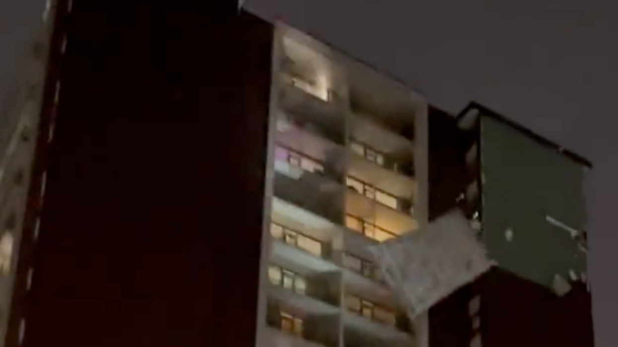 Chunk of Toronto building falling off in high winds.